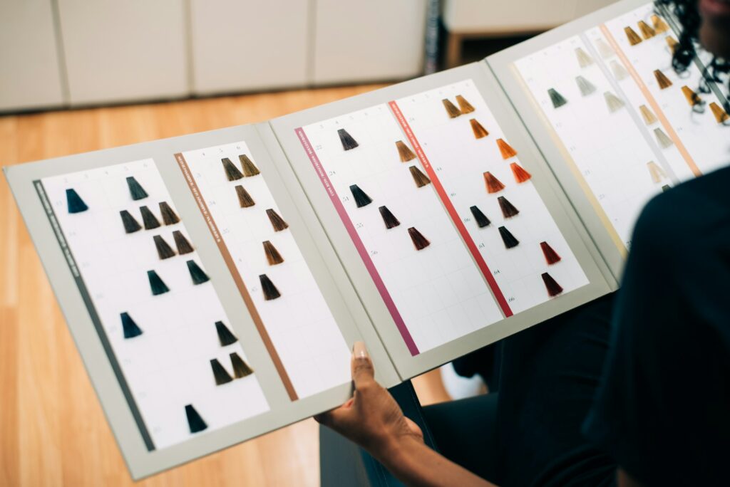 Woman choosing hair color in dye catalog